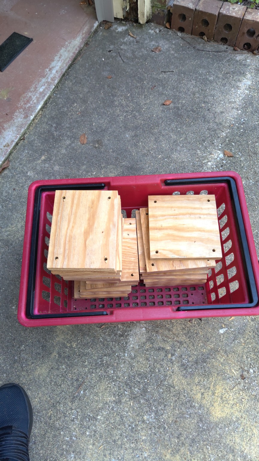 Cut and drilled plywood boards stacked before assembly